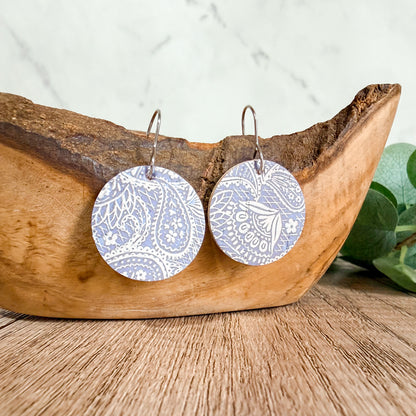 Pastel purple paisley leather earrings photographed on a clean background with hypoallergenic hooks. Handmade lightweight pair with unique pattern placement.