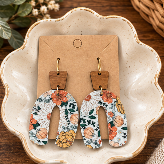 Autumn floral wood top open arch earrings styled in a ceramic dish