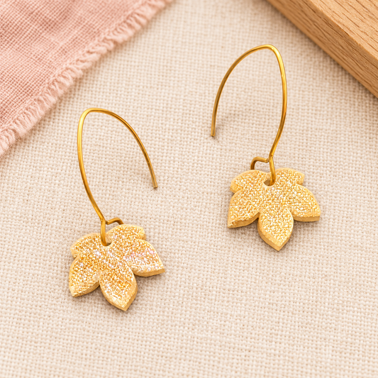Champagne gold glitter acrylic leaf earrings with gold-tone stainless steel hooks