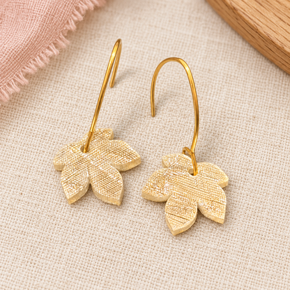 Pale gold textured acrylic leaf earrings with gold-tone stainless steel hooks