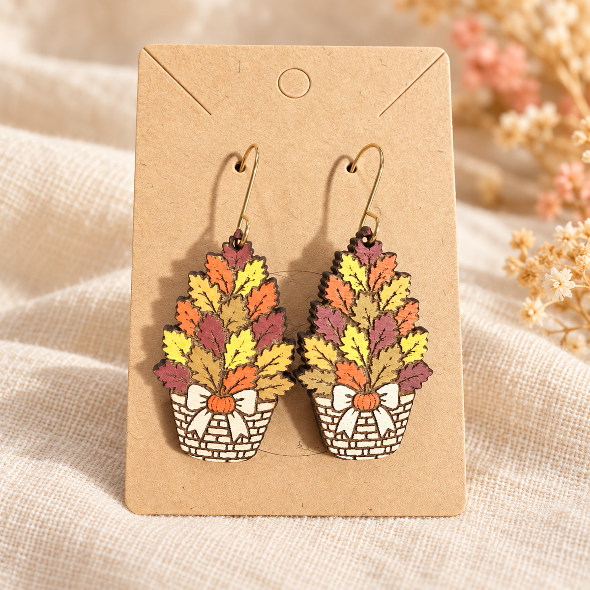 Hand-painted wood earrings shaped like fall leaf baskets