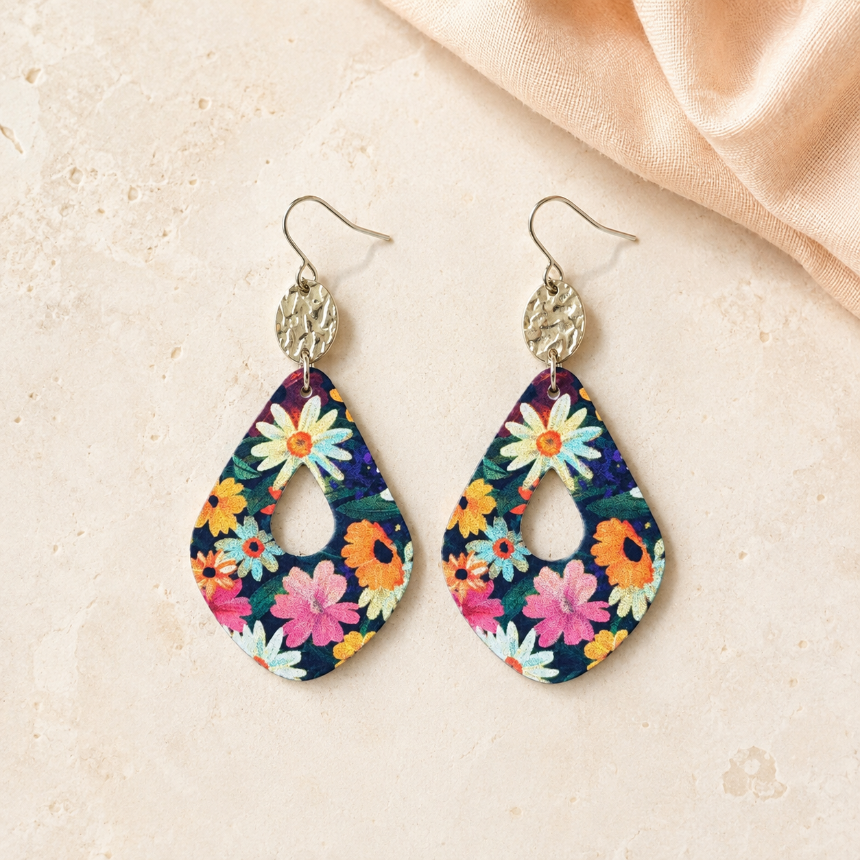 Colorful navy floral teardrop earrings with round hammered gold accents.