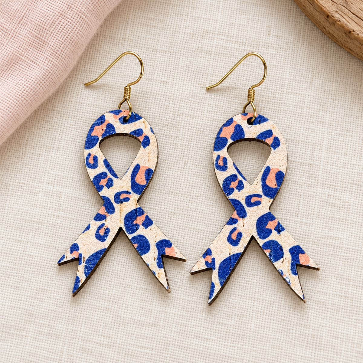 Cream, navy and peach leopard-print ribbon earrings with gold hooks.