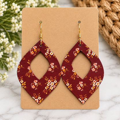 Maroon floral open teardrop earrings with gold hooks on a blank kraft card