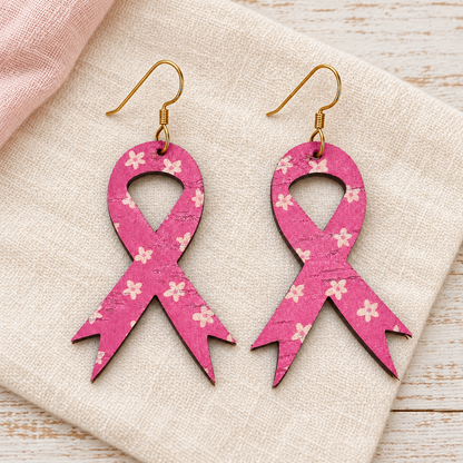 Pink floral awareness ribbon earrings with gold hooks on ivory linen.