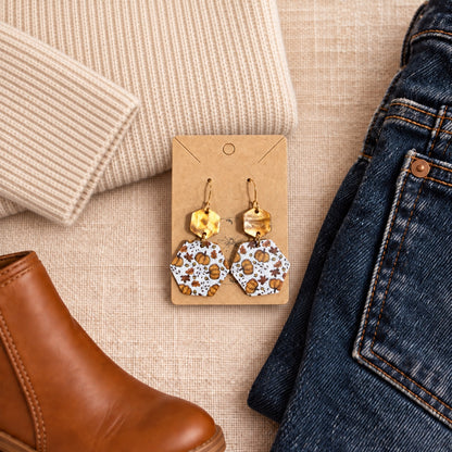 Pumpkin patch acrylic earrings styled with a cream sweater, dark denim, and a cognac boot