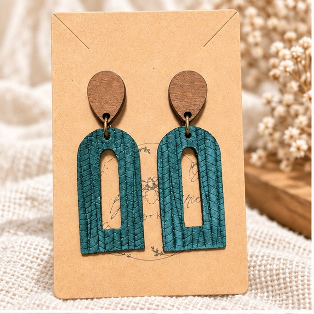 Dark teal palm petite open arch earrings on display card